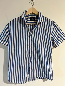 Lightweight short-sleeve button-down with a multicolor plaid weave. Neat collar and clean front placket. Subtle embroidered logo on chest. Versatile c
