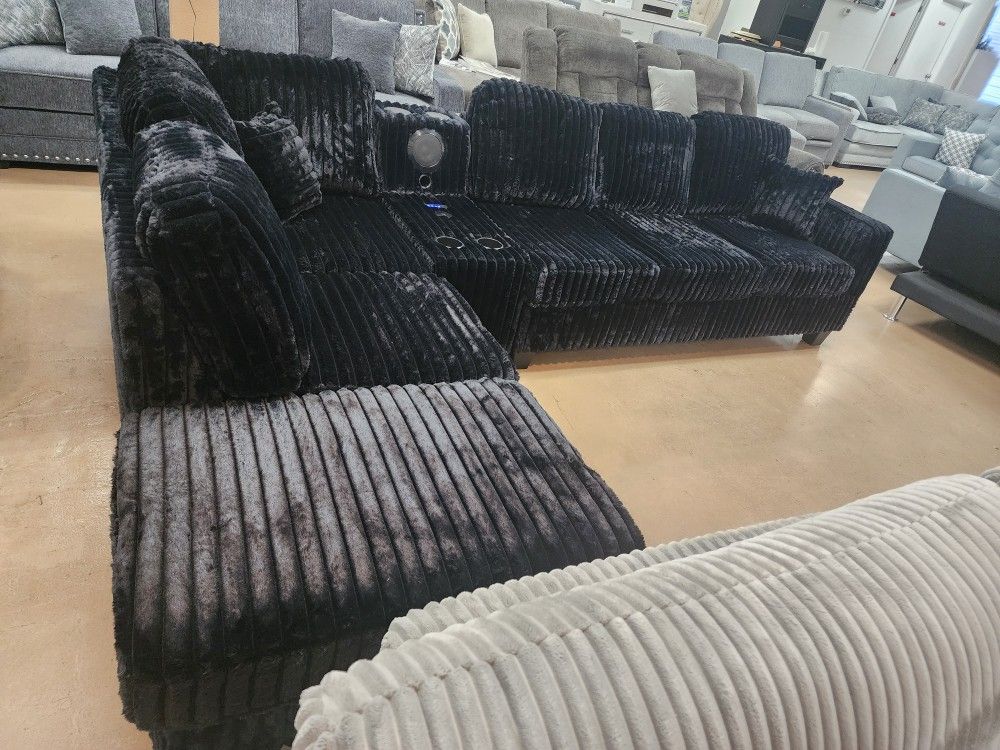 Black Sectional With BLUETOOTH SPEAKER CONSOLE AND WIRELESS CHARGING W/ 4 CUPHOLDERS