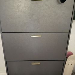 Gray Shoe Cabinet With Gold Accents