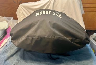 black Weber Q 1200 portable propane gas grill