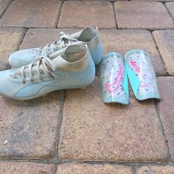 Girls size 6.5 Puma soccer shoes and shin guards.