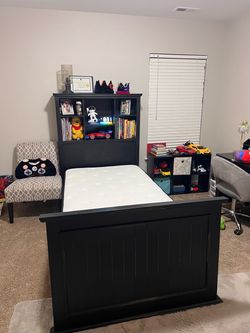 Twin bed with shelf head board