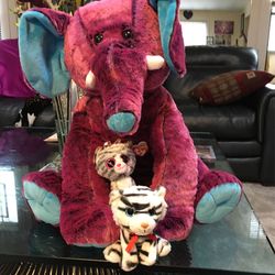 One elephant and two cats stuffed animals