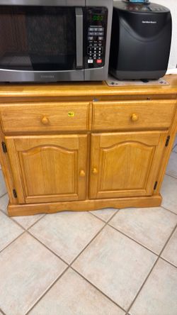Solid oak cabinet with drawers and shelving.