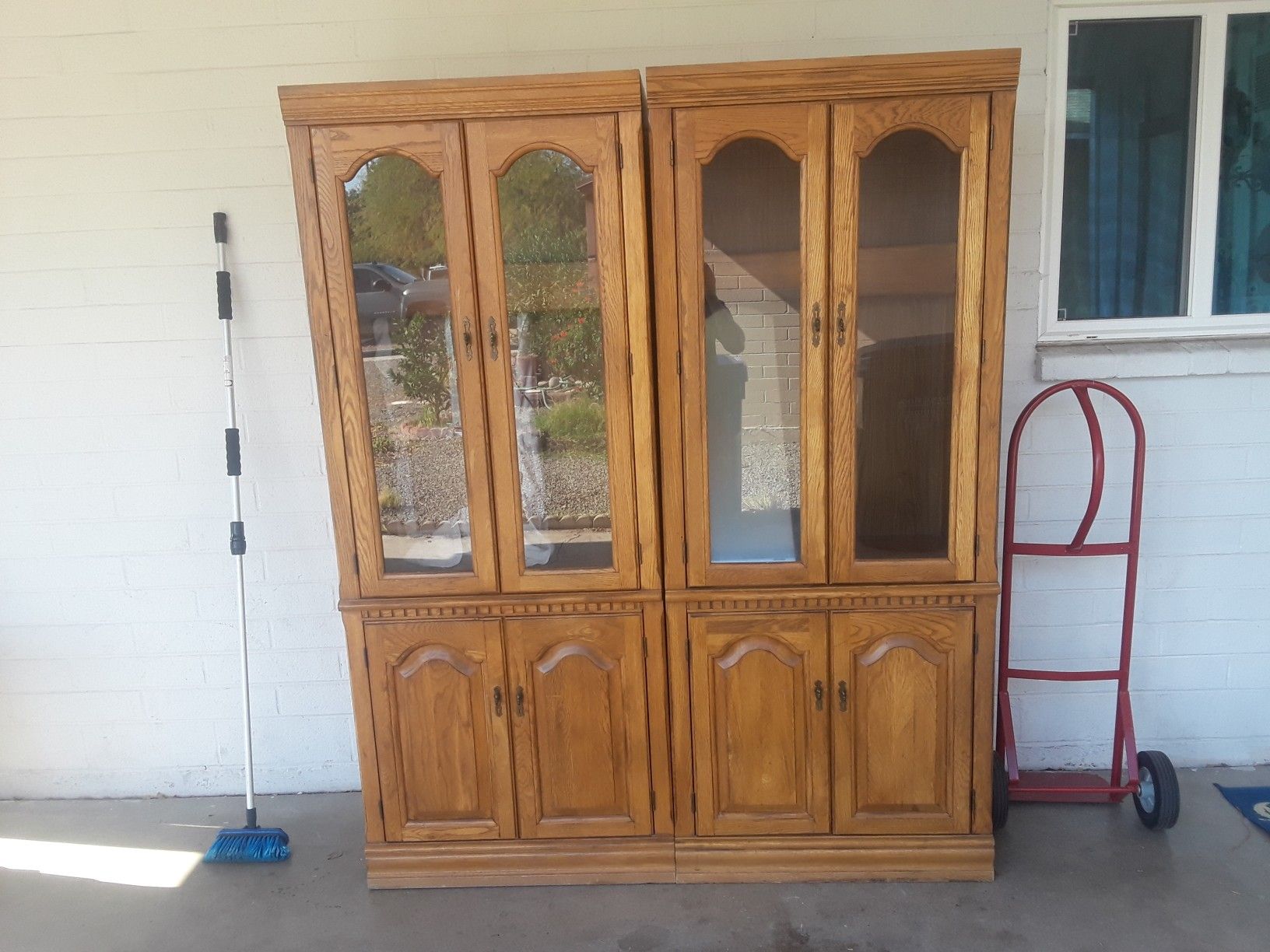 2 solid wood cabinets with glass shelfs