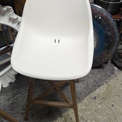 2 White Ikea bucket bar stools with wooden legs. Measures 26in from floor to seat