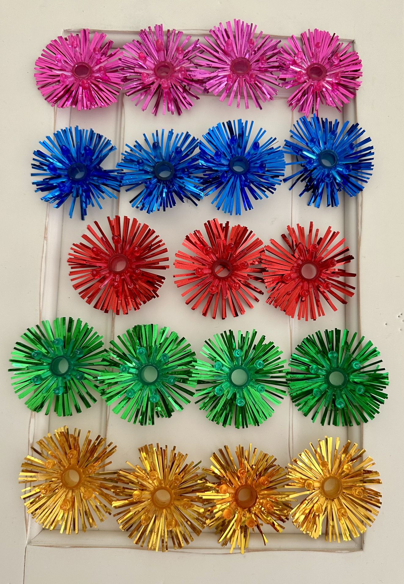 Lot of 19 Vintage Christmas Light Foil Tinsel Reflectors. Larger sized at 2 1/2”. Multi colors 4 pink , 4 blue, 4 green, 4 gold and 3 red.