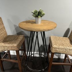 Wicker barstools and raised cocktail table