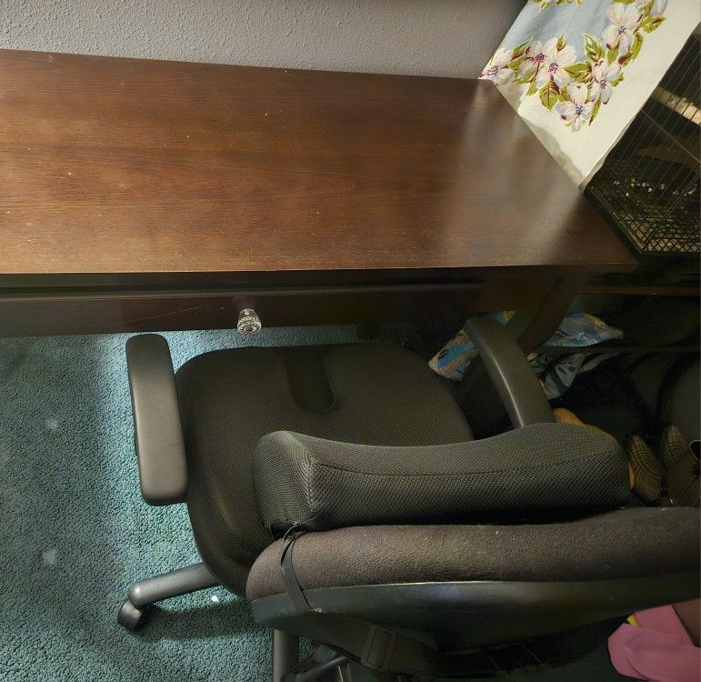 Dark Walnut Desk And Black Office Rolling Chair With Lumbar Seat Cushions