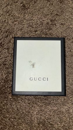 Gucci black leather bifold wallet with the classic green/red Web stripe.