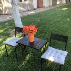 Out door black end table & 2 chairs with cushions