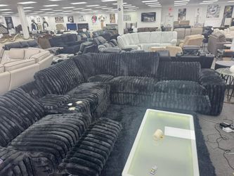 Plush corduroy black large power reclining sectional with surround sound.