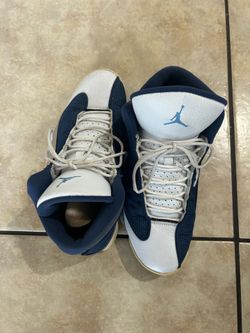 Jordan 12 white and blue trainers.