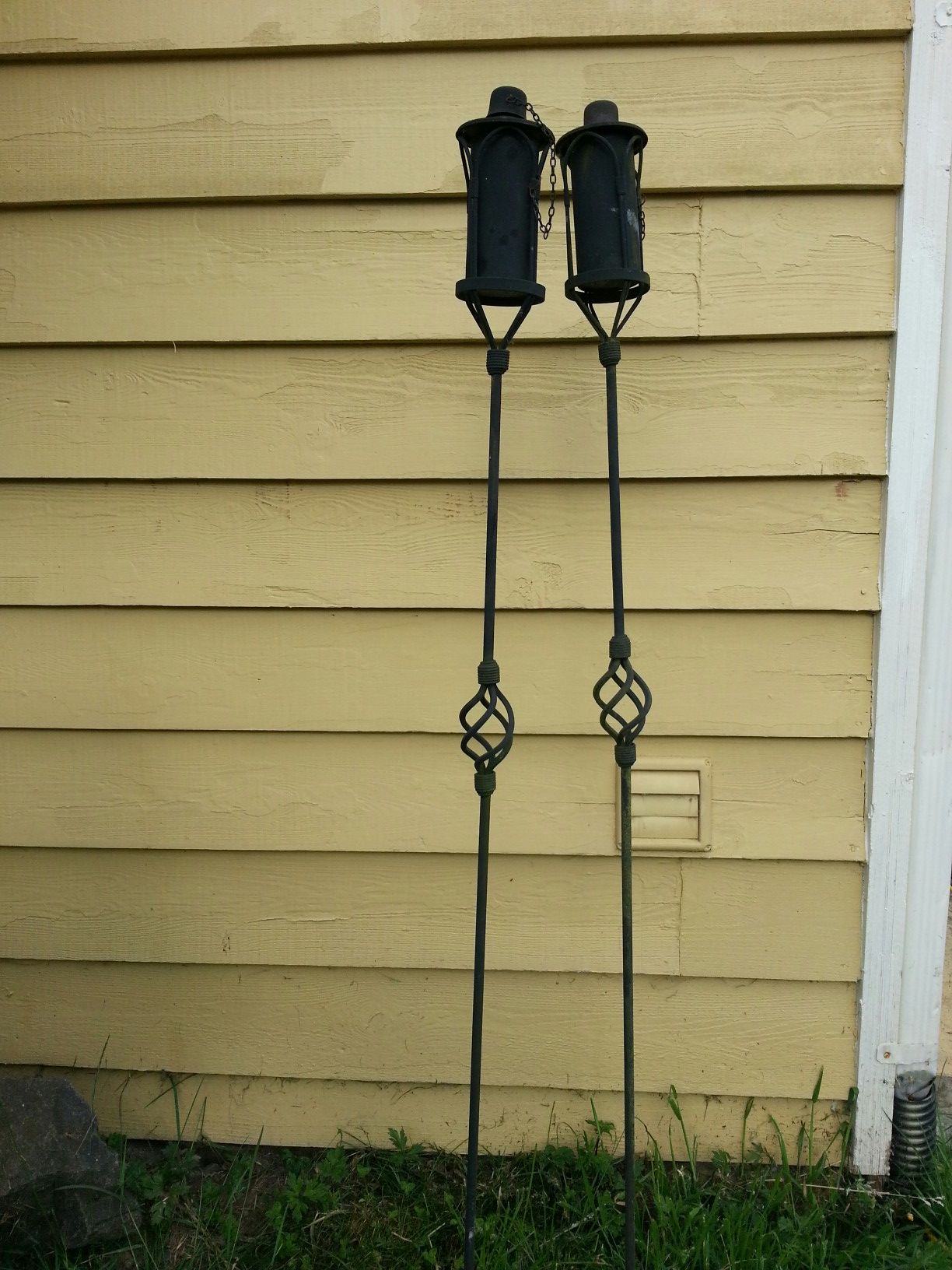 Wrought iron tiki torches with torch fuel.