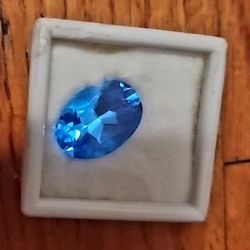 Oval-shaped blue topaz gemstone
