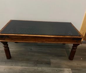 48” L × 24” W × 23” H solid wood coffee table featuring a removable tempered glass top