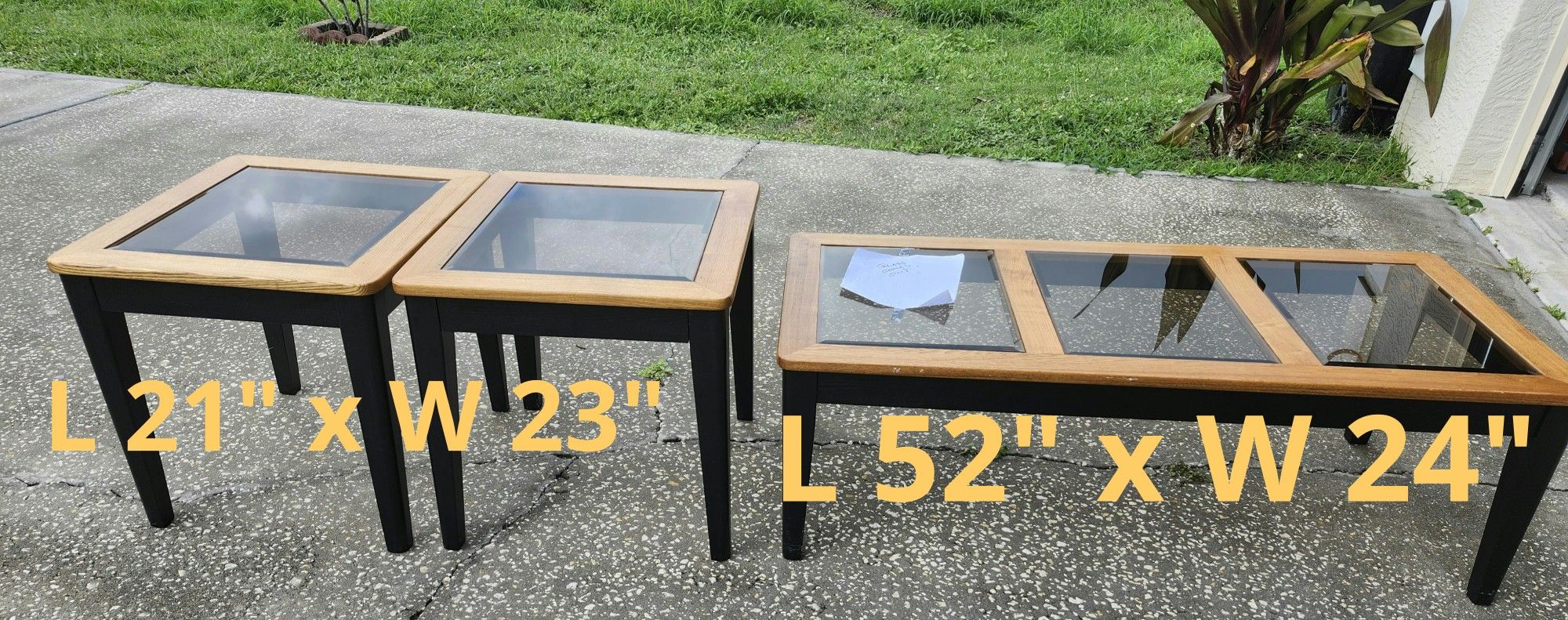 Set of glass top tables. Coffee table: L 52" x W 24". Side tables: L 21" x W 23".