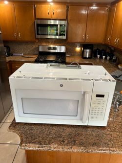GE 1.6 microwave over the stove 30 inch width mint condition in box complete hardware included 50$.