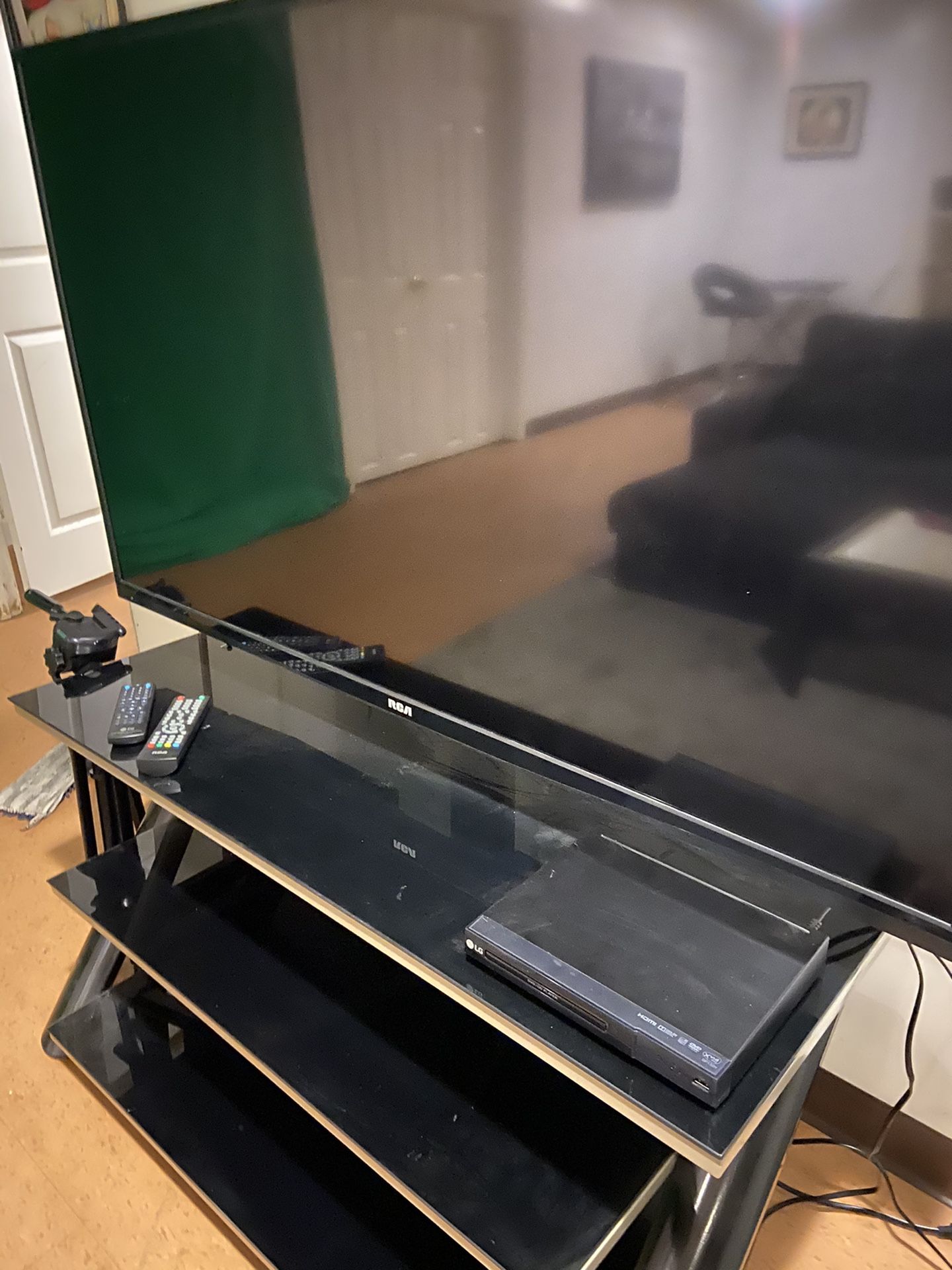 55 in RCA flat screen TV, black steel and glass stand and LG DVD player