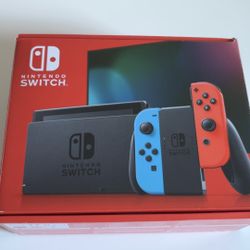Nintendo Switch with neon red and blue joycons AND Super Mario Bros Deluxe