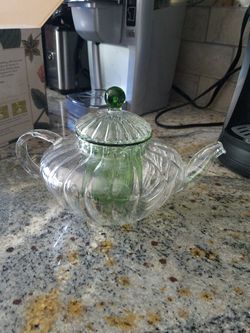 Glass tea kettle with blooming flower tea