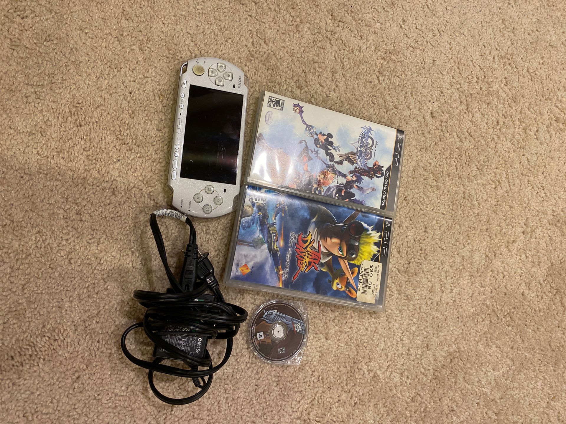 PSP with a charger and 3 games (Kingdom hearts, Jak and Daxter, GTA)