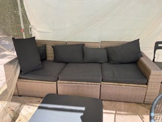 Outdoor Wicker Sofa with Black cushions. In excellent condition