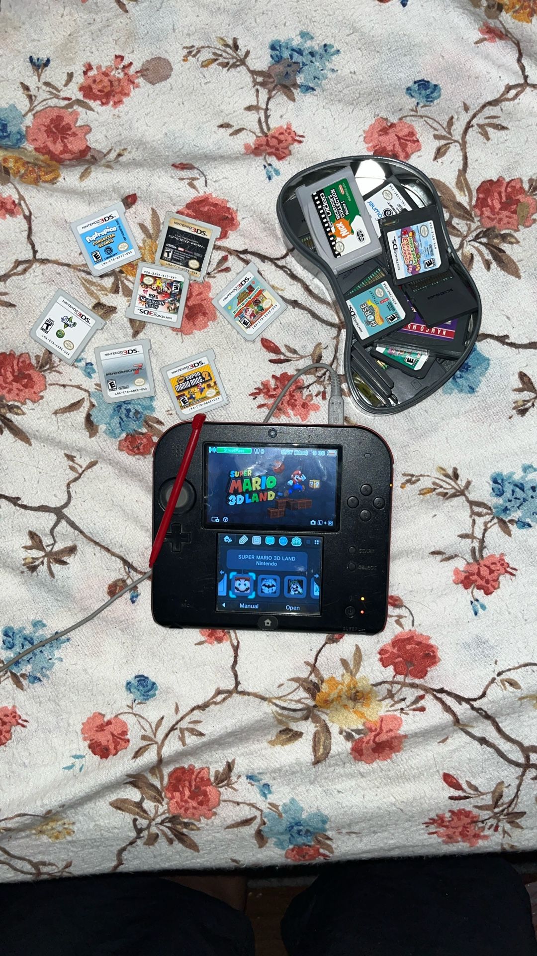 nintendo 2ds with a bunch of games 