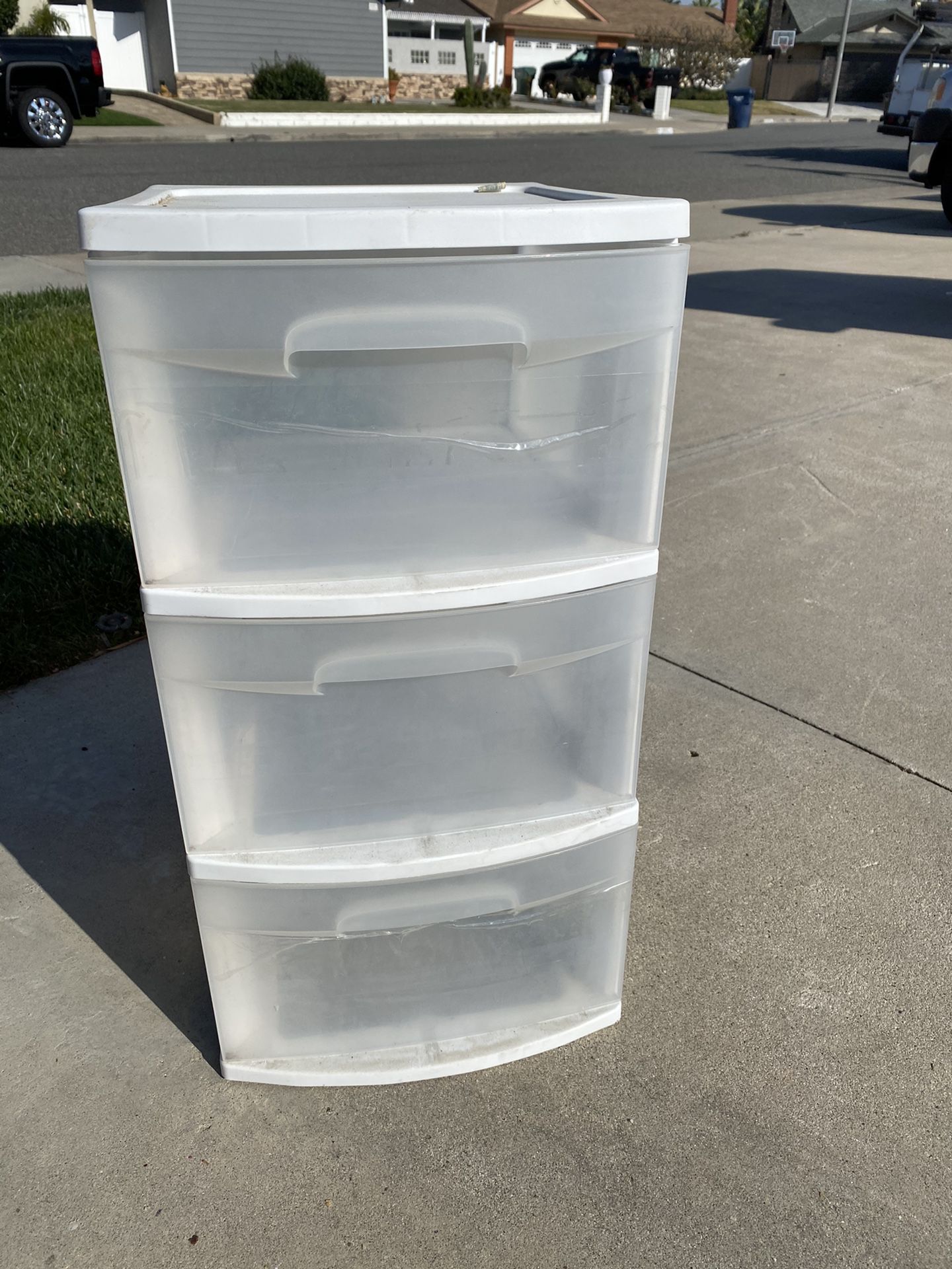 Two plastic storage containers with all three drawers
