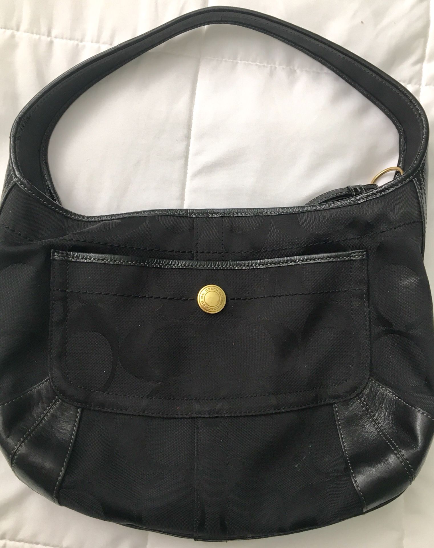 Black and gold signature Coach purse