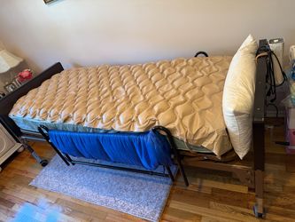 Electric bed with guard rails