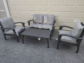 Outdoor patio wicker loveseat with chairs and coffee table