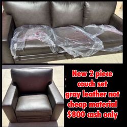 New Couch Set Gray Leather 2 piece includes   1 three seater 1 single seater I have the legs there still wrapped & sealed $800  cash only no delivery 