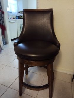 2 leather swivel dining chairs