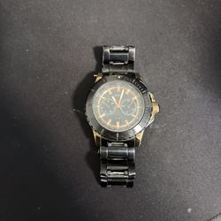 GUESS Men's Multifunction Watch featuring a black chain-link bracelet and gold-tone accents.