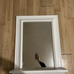 Mirror with a white frame and narrow shelf / good condition