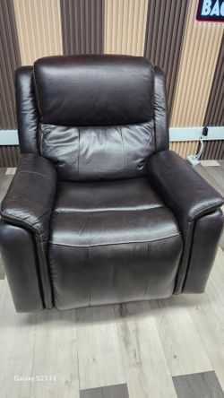 Barcalounger Bryson recliner is crafted from brown top-grain leather and features power reclining with an adjustable headrest.