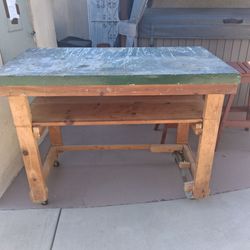 Wooden work Bench -.Metal top and wheels