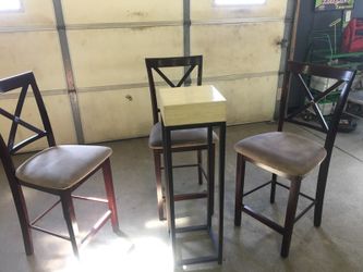 Three chairs and a plant stand