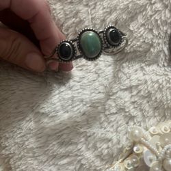 925 sterling silver cuff bracelet with an oval green onyx center stone and two oval black onyx side stones