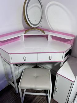 Corner vanity with lights, plugs, and cabinets.