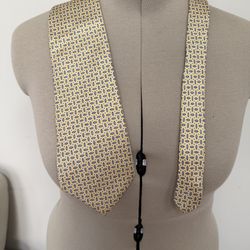 yellow silk necktie from Lauren Ralph Lauren featuring a blue and white geometric pattern.