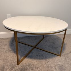 Round White Marble-Look Coffee Table with Gold X-Base Frame — Modern/Glam Style