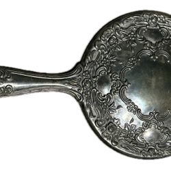 Silver plated hand mirror with ornate floral repousse Art Nouveau design in the Victorian style.
