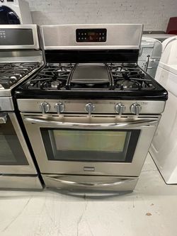 Frigidaire stainless steel natural gas stove; includes a receipt for a 90-day warranty.