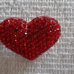 Sparkling red heart-shaped rhinestone brooch.
