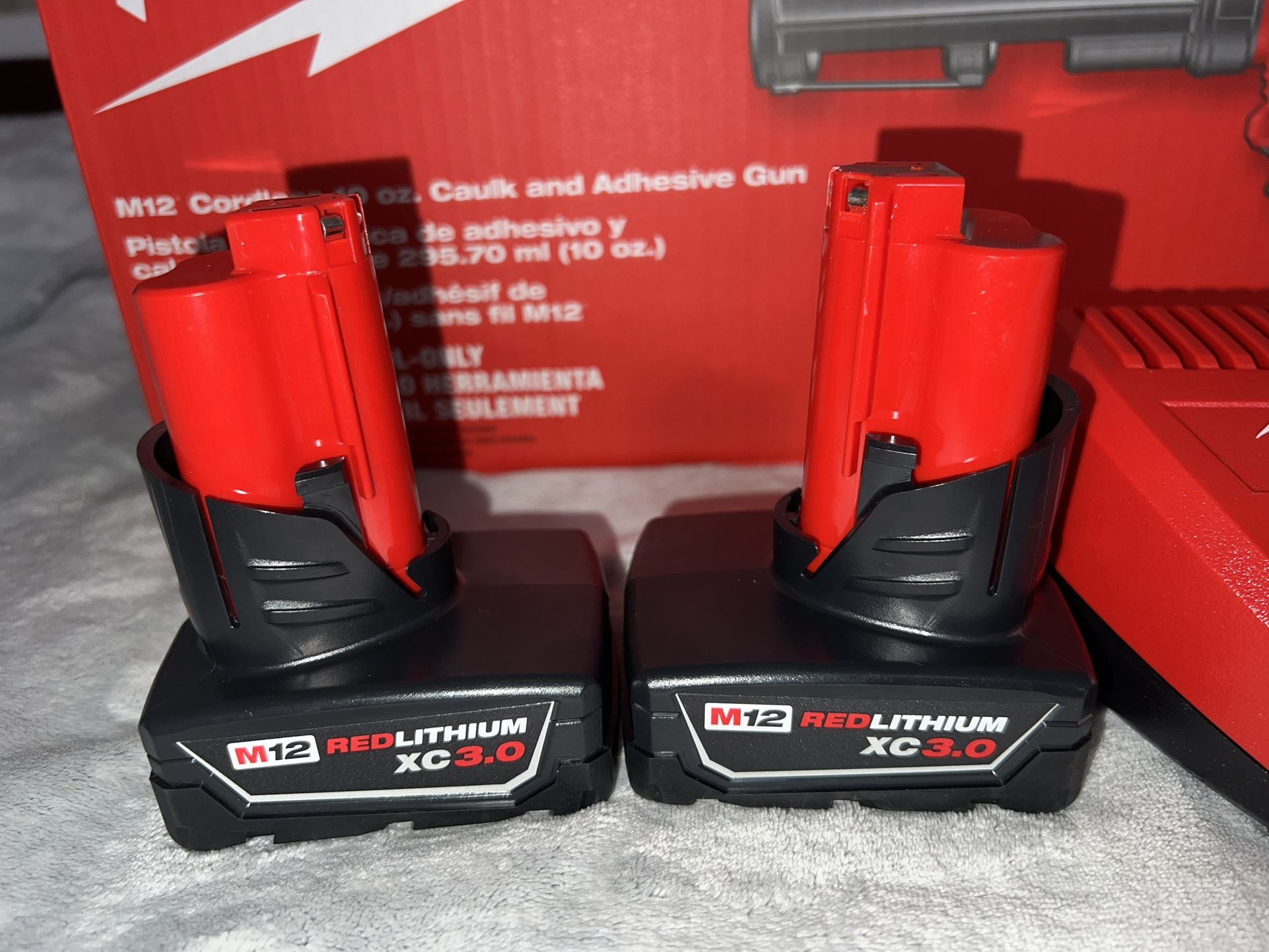 Milwaukee M12 Charger And Batteries And Caulking Gun