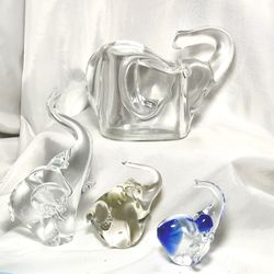 Glass Elephant figurines/ paperweights/piggy bank. all 4 have trunks up for good luck! Beautiful