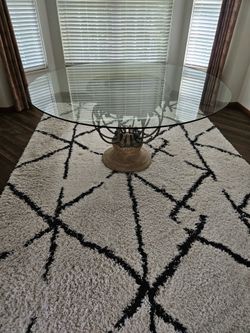 Round glass top dining table with ornate base