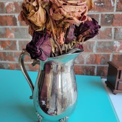 Silver Pitcher Used As Vase With Flowers 